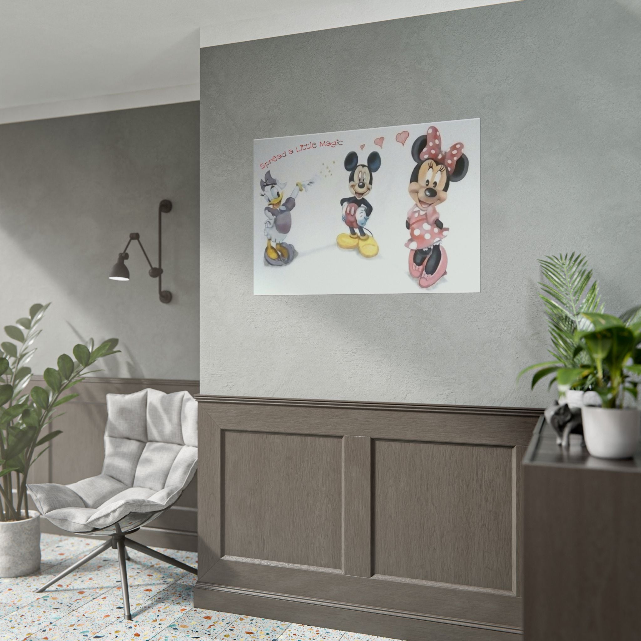 A framed wall art print featuring Disney characters Mickey Mouse, Minnie Mouse, and Donald Duck hanging on a gray wall in a styled room with wood paneling, a chair, and plants.