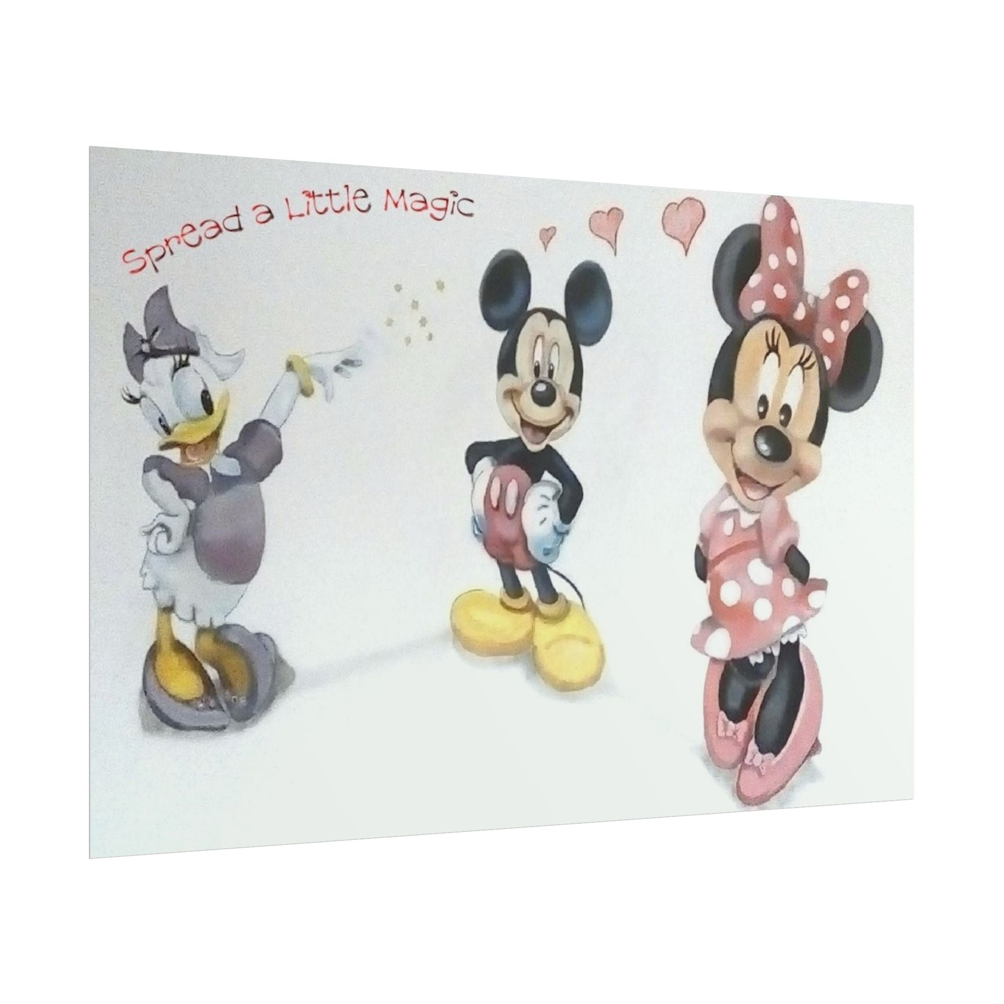A square wall art print featuring Disney characters Mickey Mouse, Minnie Mouse, and Donald Duck with the text 'Spread a Little Magic' and small hearts, shown against a plain white background.